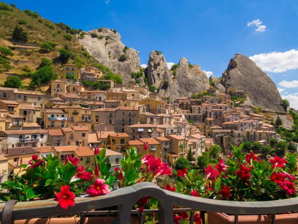 The hilltop village of Castelmezzano clinging to jagged cliffs in the Lucanian Dolomites under morning light.