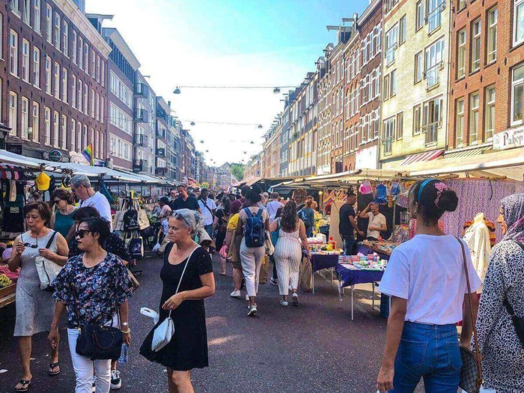 Colourful stalls and shoppers at Albert Cuyp Market in De Pijp
