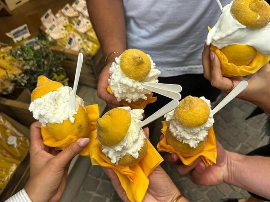 Delizia al limone on a plate dusted with powdered sugar.