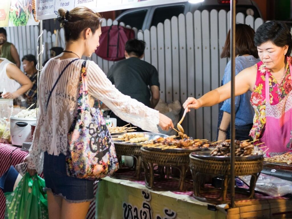 Eating local street food to save money while traveling