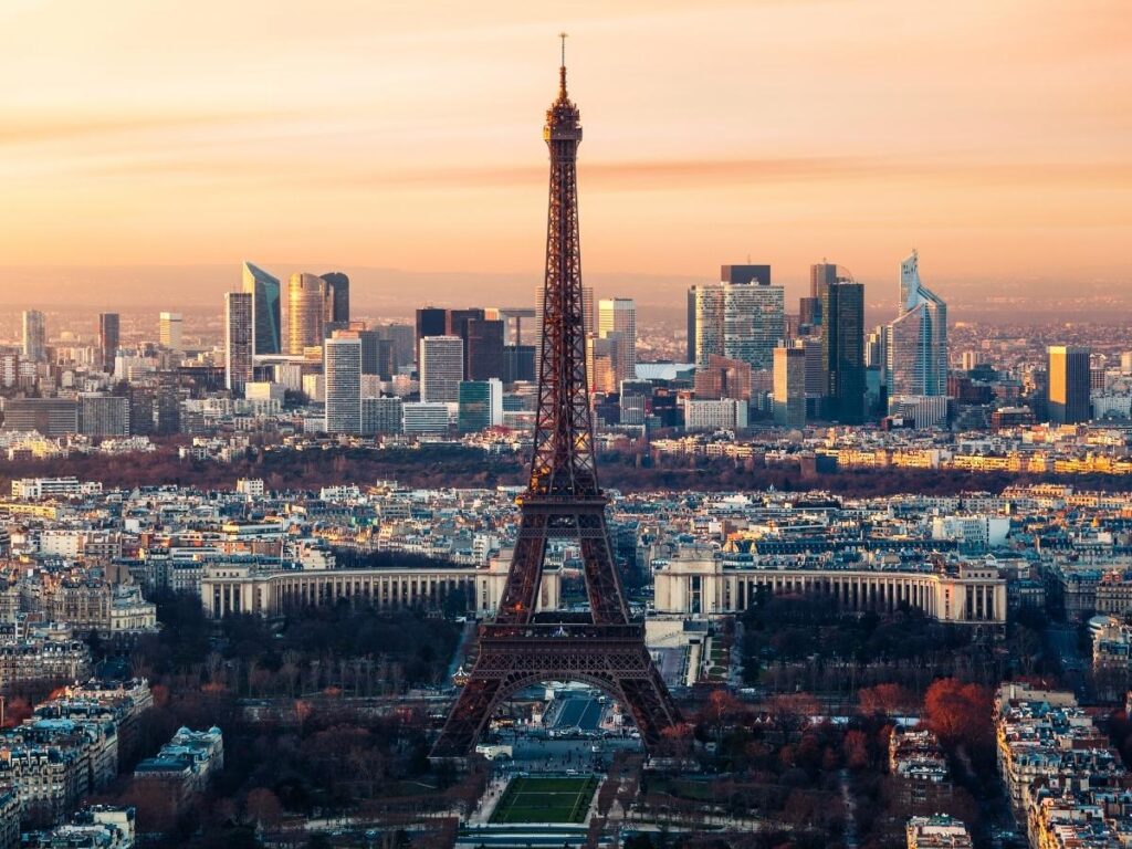 The Eiffel Tower illuminated at twilight, seen from Trocadéro.