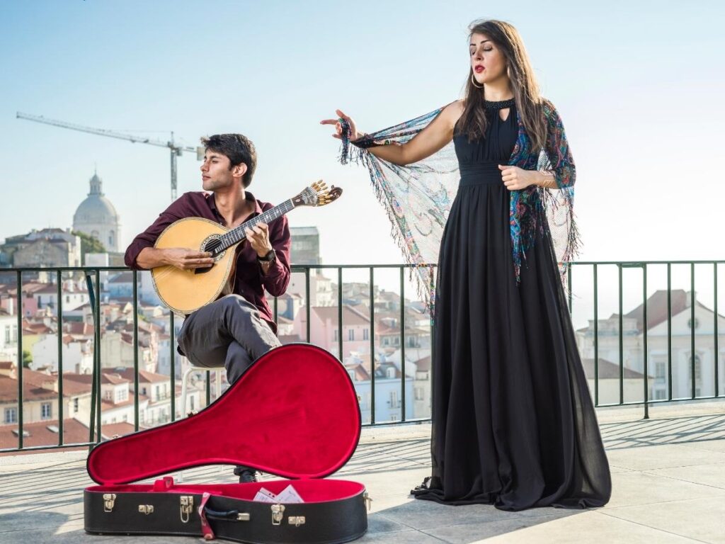 Singer performing fado in a dimly lit, intimate Alfama fado house with attentive diners