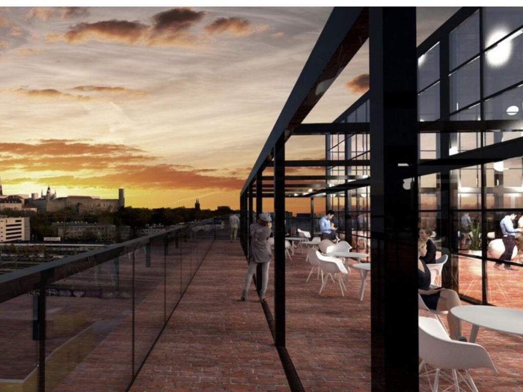 People enjoying drinks by floor-to-ceiling windows at Fotografiska at golden hour.