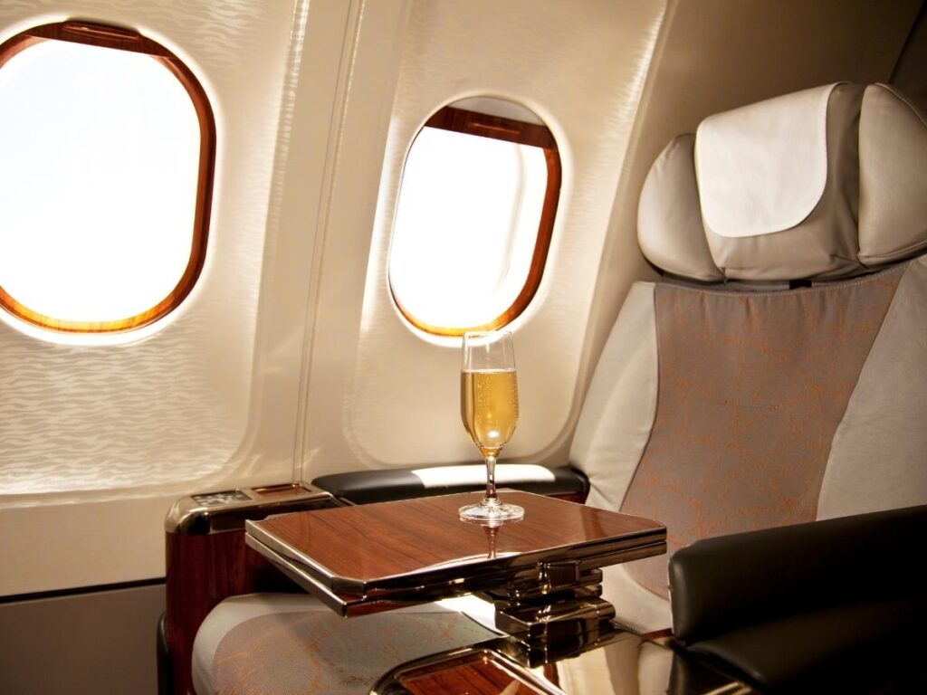 Business class airline seat with free upgrade perks and champagne