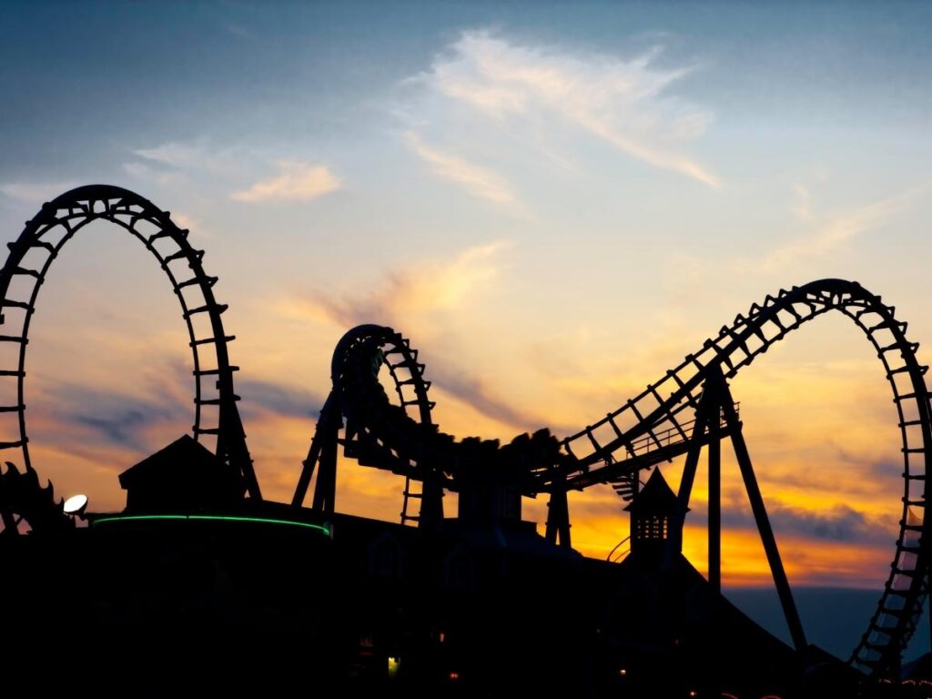 Gardaland park rollercoaster and families enjoying rides near Lazise