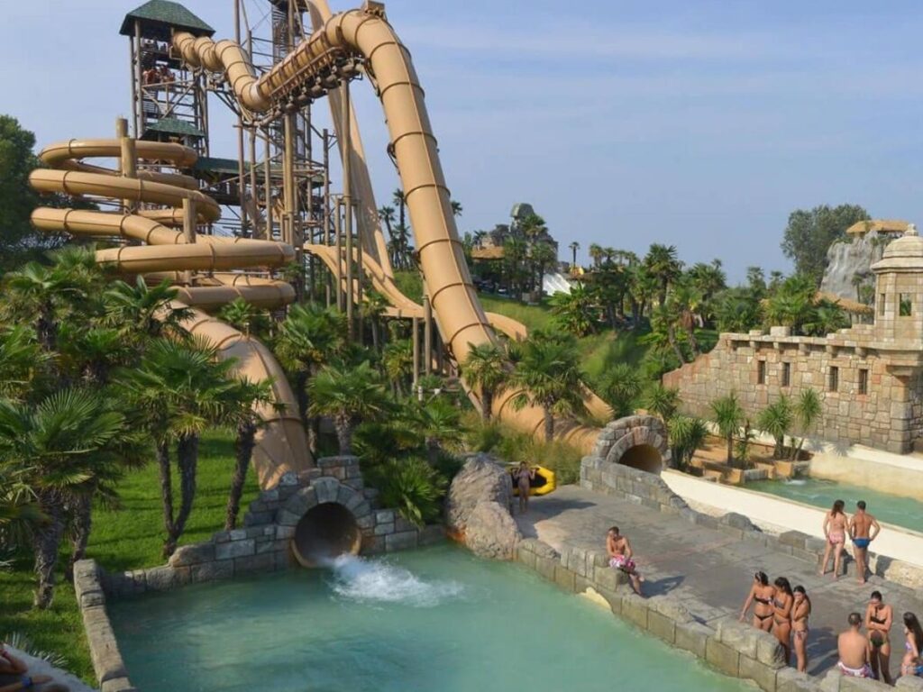 Tall waterslide and turquoise pools at Caribe Bay waterpark near Jesolo.”