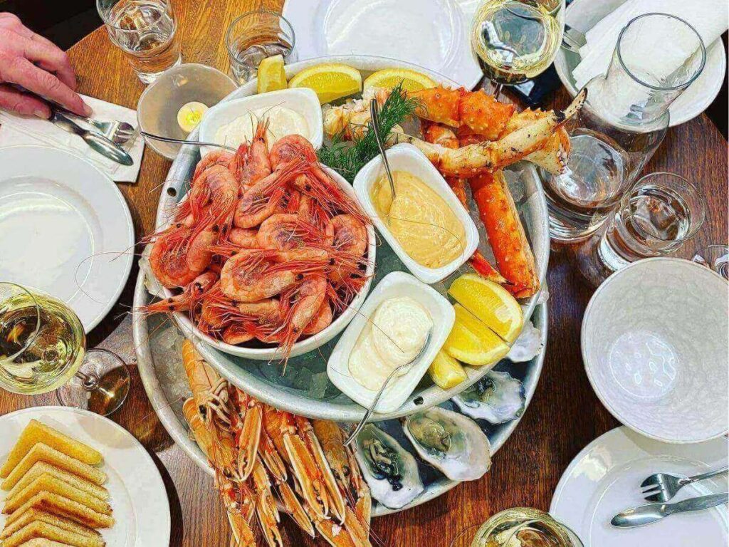 Bowl of creamy fish soup with dill, served at a busy market stall.