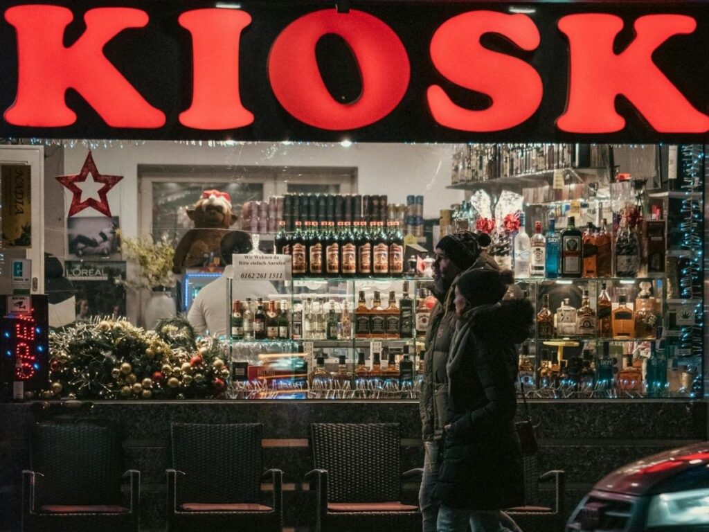 Small late-night pastry kiosk near Malostranské náměstí with a warm pastry and espresso to-go in hand.