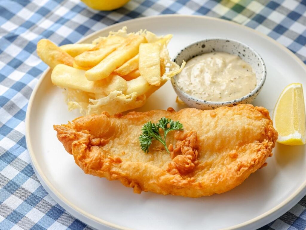 Traditional British pub serving fish and chips with a pint of beer inside a cozy London bar