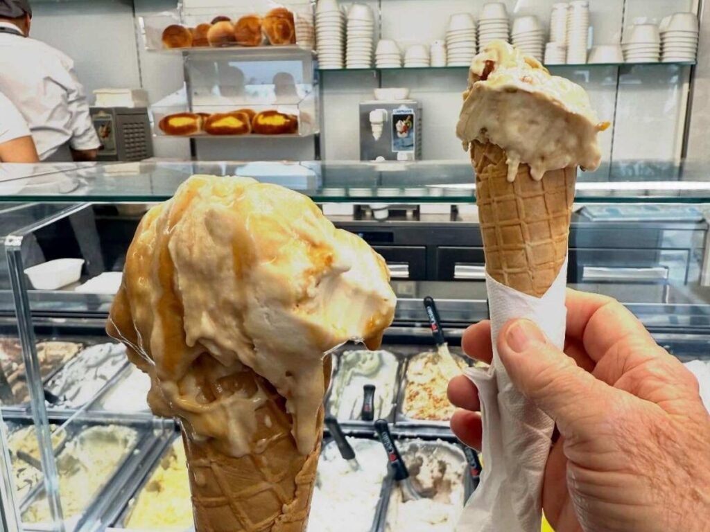 Evening stroll on Lungomare Trieste with people, gelato and string lights