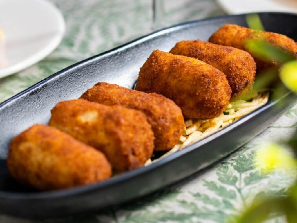 Traditional Spanish tapas — croquetas, jamón ibérico, and padrón peppers served in Madrid