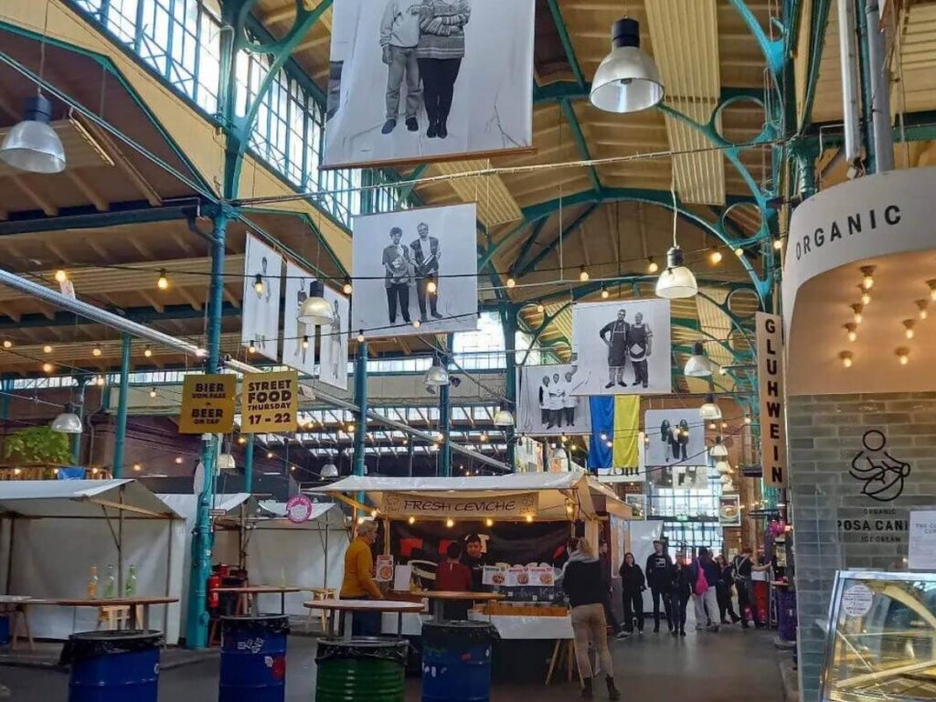 Crowds enjoying street food and local stalls inside Markthalle Neun market in Kreuzberg, Berlin