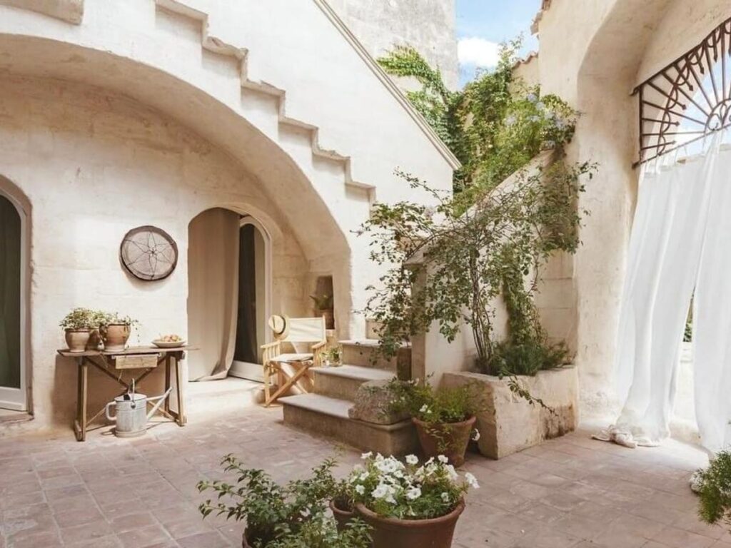 Cozy guest room in a family-run B&B in Sasso Barisano with simple furnishings and warm lighting.