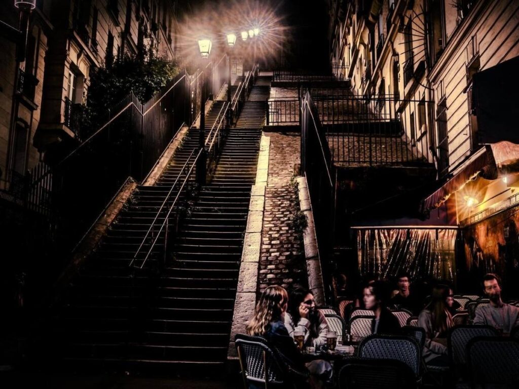 Steps of Montmartre leading up to the Sacré-Cœur Basilica under a blue sky