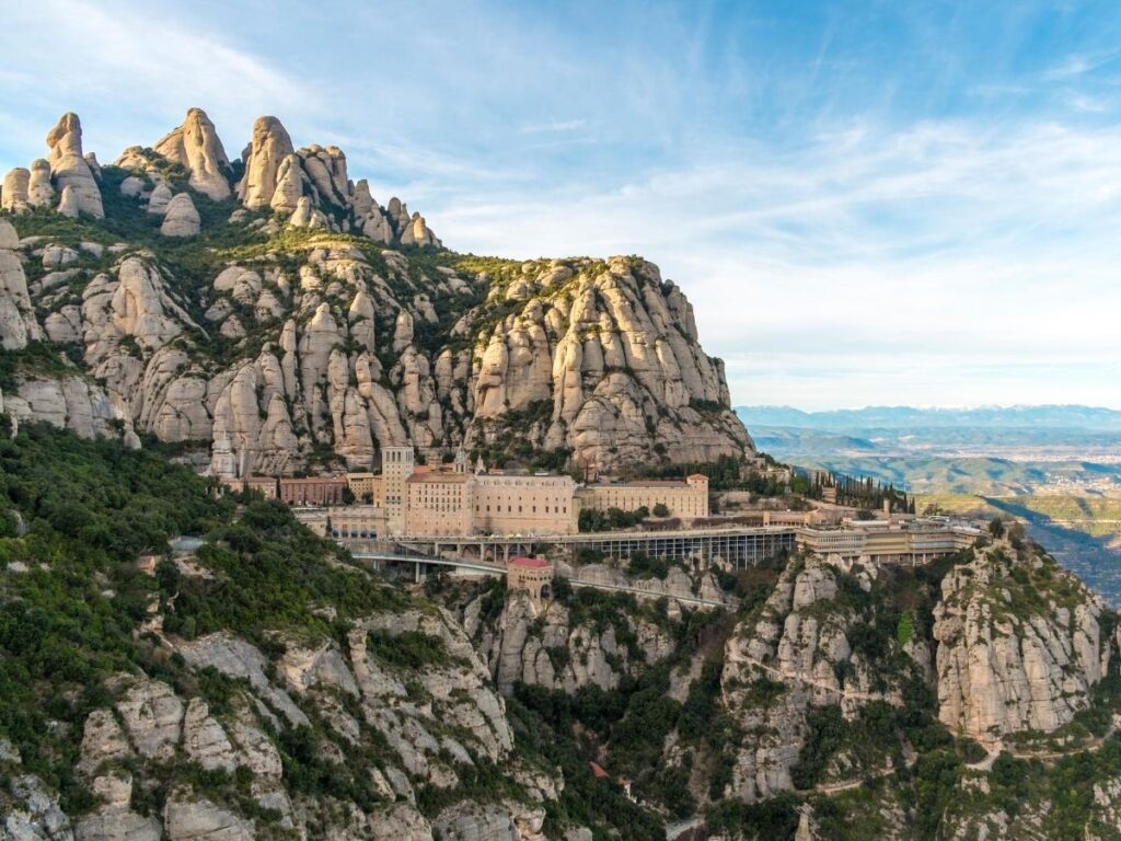 “Montserrat monastery perched on rocky cliffs with panoramic views