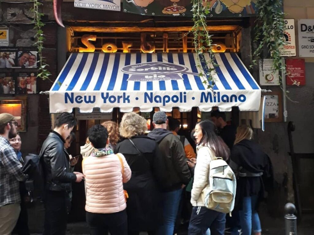Classic Neapolitan pizza being served at Sorbillo pizzeria in Naples.