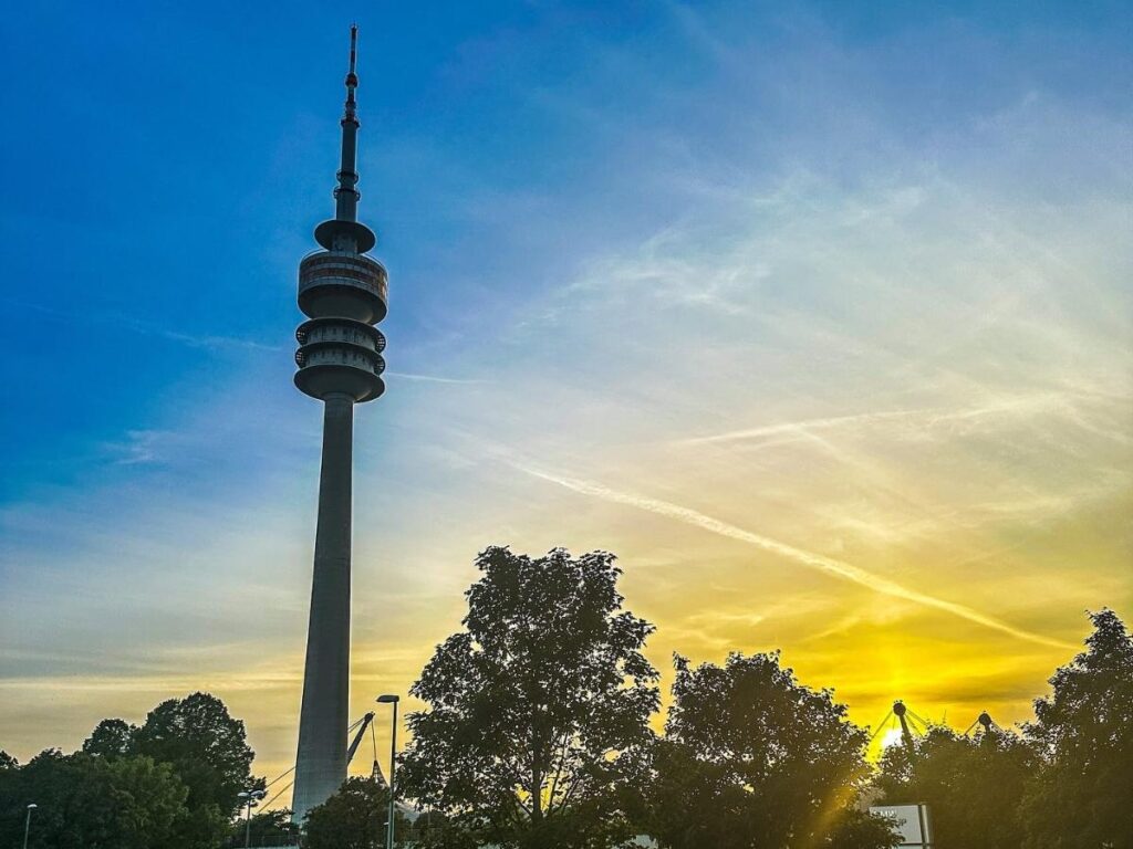 Sunset over Munich seen from Olympiaberg with silhouettes of rooftops