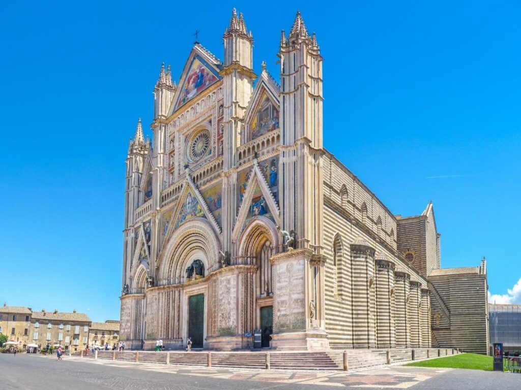 Orvieto perched on its volcanic cliff, the Duomo facade shining in sunlight
