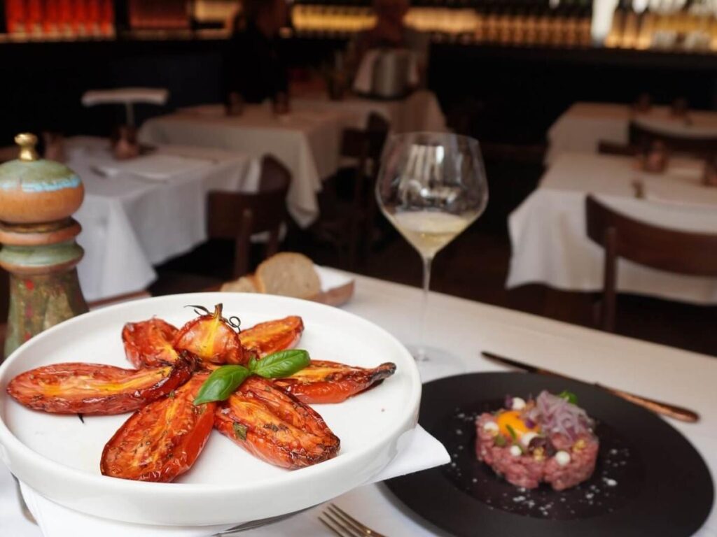 Candlelit dinner table with Amarone wine at a cozy osteria in Verona.”