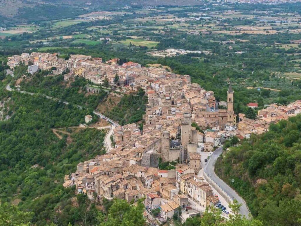 Colorful displays of sugared almonds (confetti) and a bustling market stall in Sulmona’s historic center.