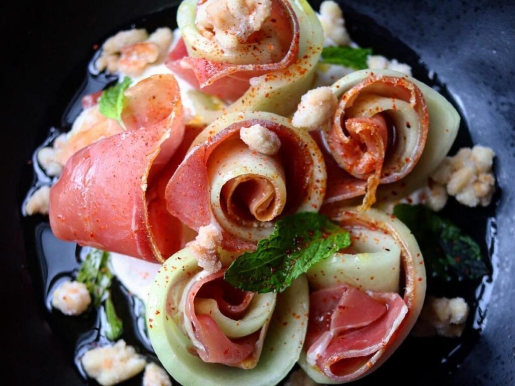 Hanging legs of Parma ham aging in a traditional prosciuttificio near Parma, Italy
