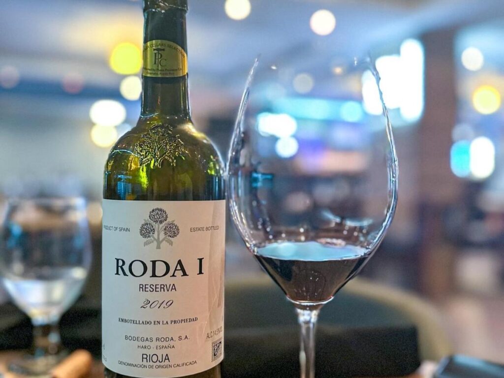 Vineyard rows in Penedès with guests tasting cava