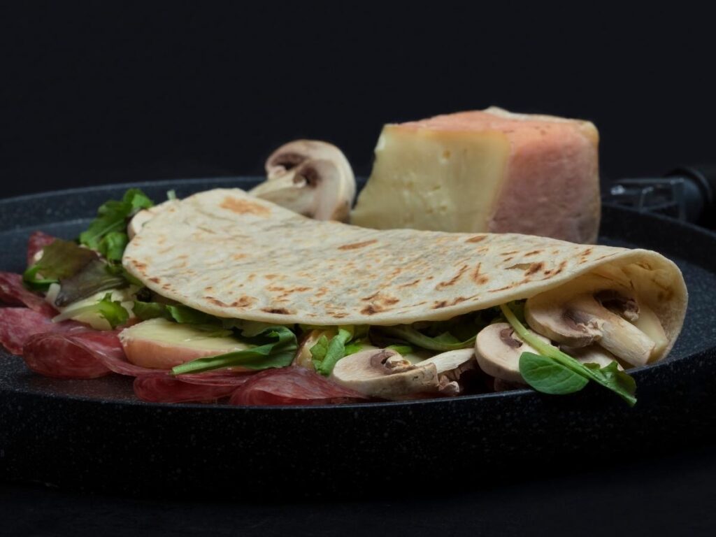 Fresh piadina flatbread being served at a beachside kiosk in Riccione