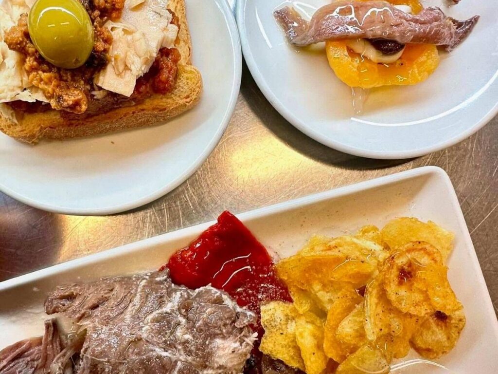 Montaditos and small tapas plates lined up in a Poble-sec bar