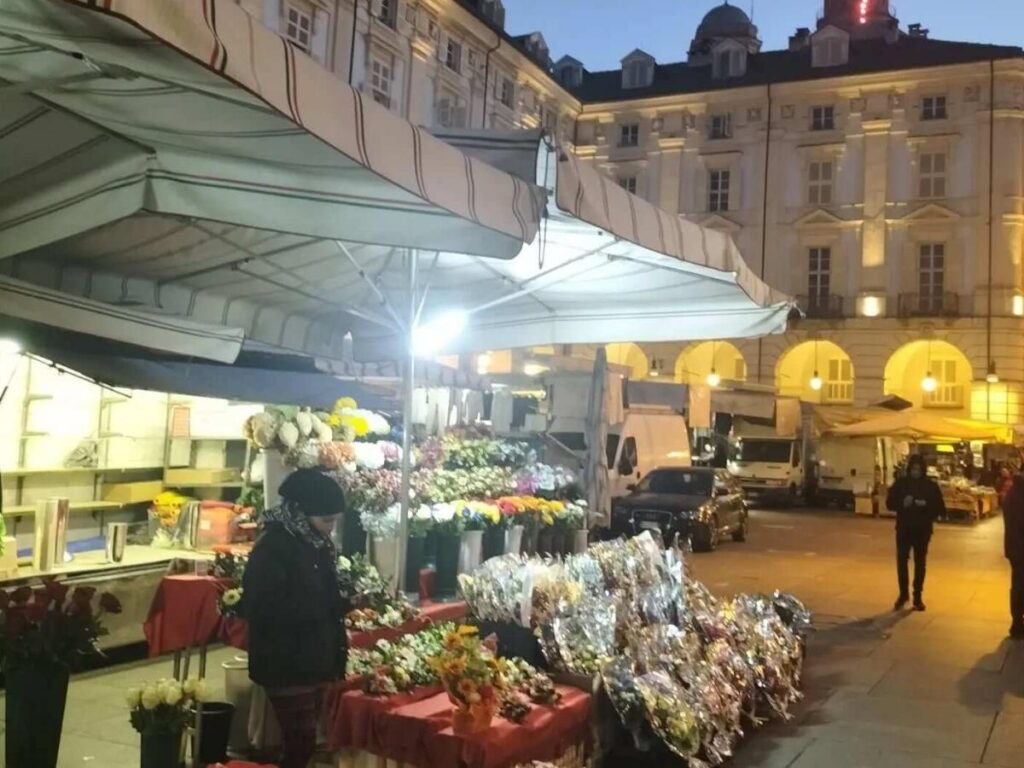 Colorful fruit and vegetable stalls at Porta Palazzo market, Turin.