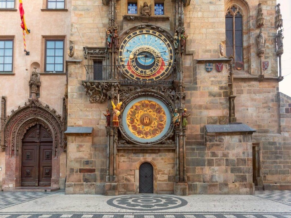 The Astronomical Clock on Old Town Hall with pastel buildings and morning light, Old Town Square, Prague