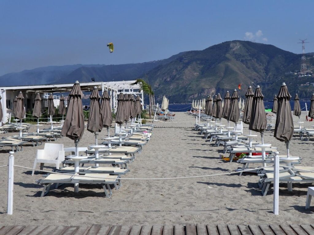 Towel and sandals on the free beach near Punta Faro