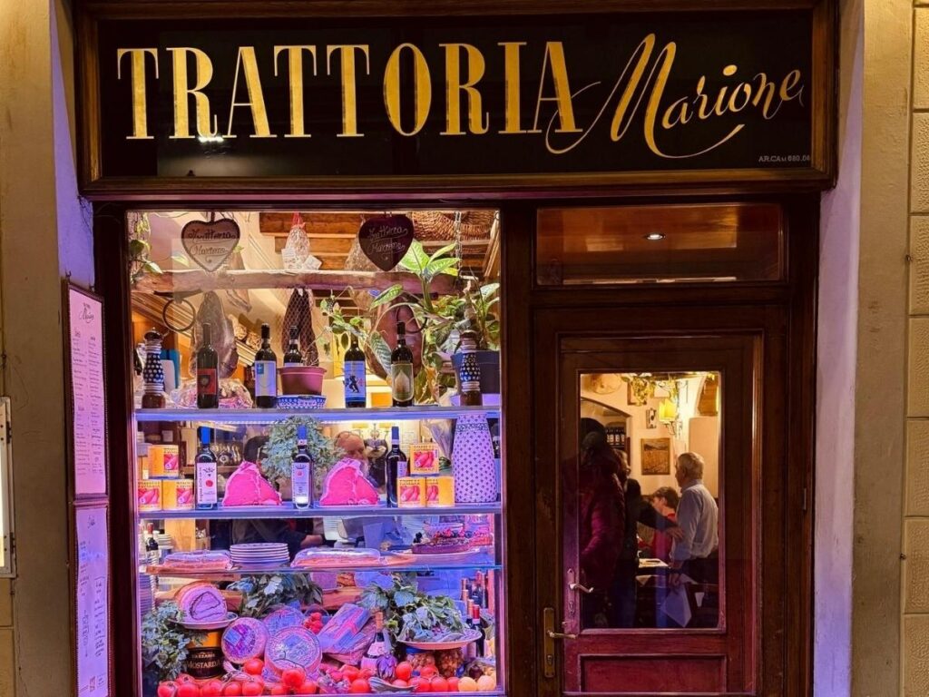 Outdoor trattoria tables in Quadrilatero Romano during lunchtime.