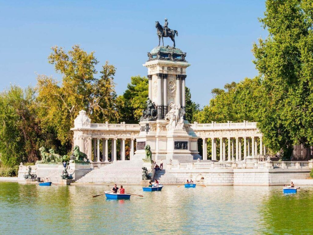 Rowboats on Retiro Park lake with the Crystal Palace reflecting in the water