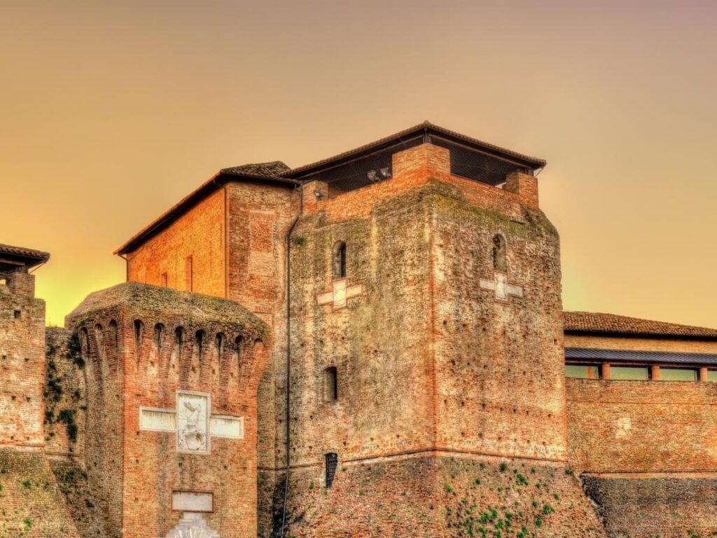 Castel Sismondo courtyard with Fellini exhibition projection at dusk.