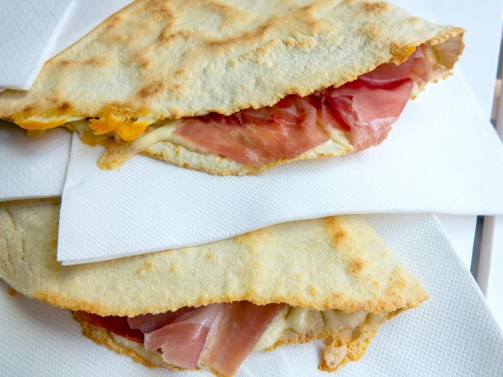 Fresh piadina filled with squacquerone cheese and prosciutto crudo, Rimini.