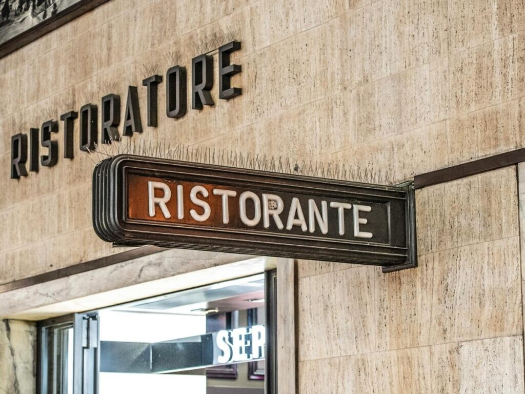 Cozy interior of Ristorante Gagini in Palermo, set with wine glasses and warm lighting