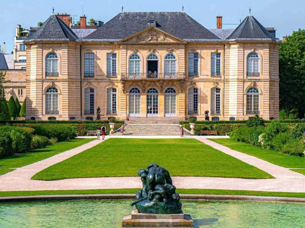 Sculptures and blooming roses in the Rodin Museum garden in Paris