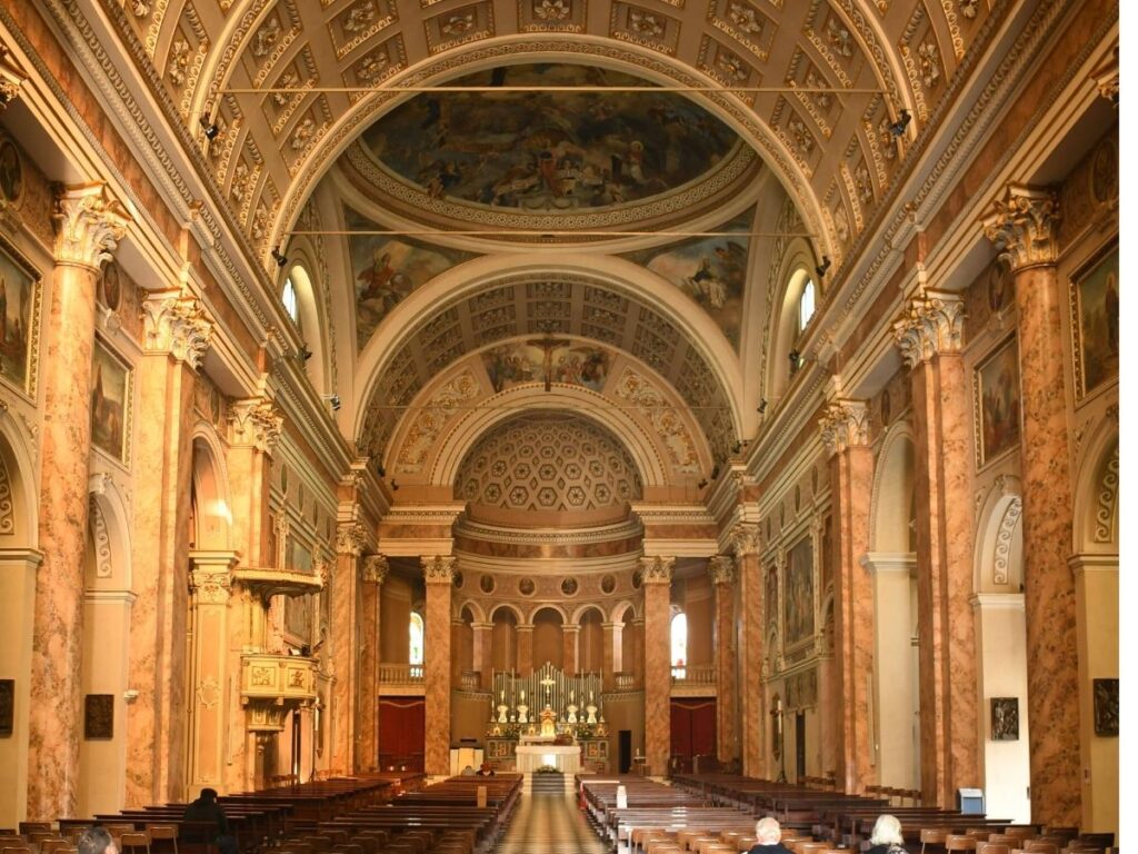 Interior of San Nicolò church near Lazise harbour showing fresco fragments and simple wooden pews
