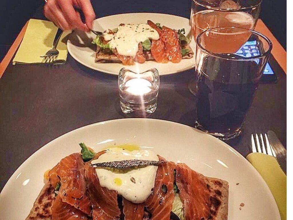 Crowded aperitivo bars and street life in San Salvario at night.