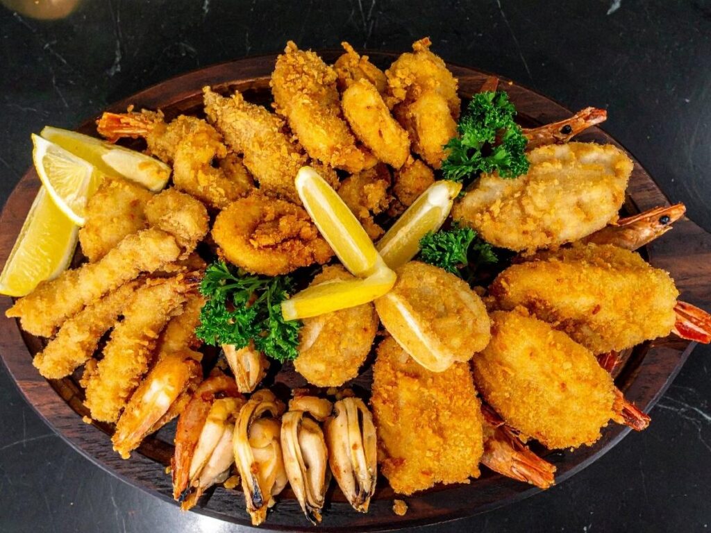 Plate of spaghetti alle vongole and white wine served at a seaside restaurant in Riccione