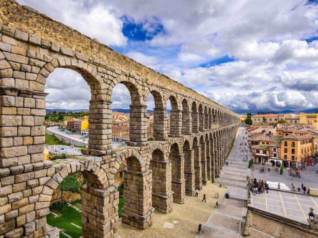 Ancient Roman aqueduct in Segovia glowing in the evening light