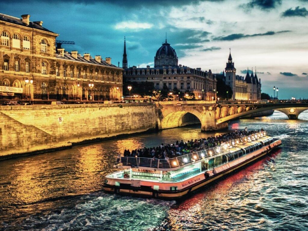 Seine River bridges and city lights reflected on the water at night in Paris