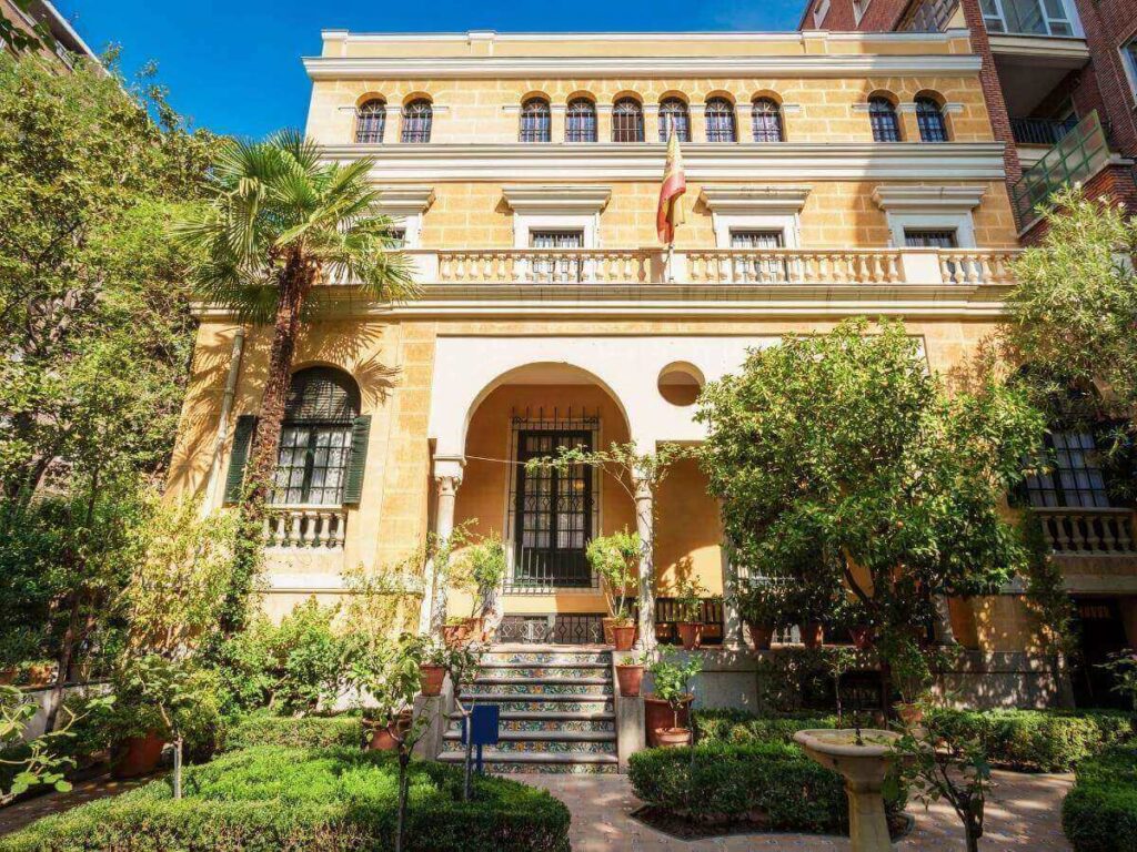 Sunlit garden of the Sorolla Museum in Madrid with impressionist paintings inside