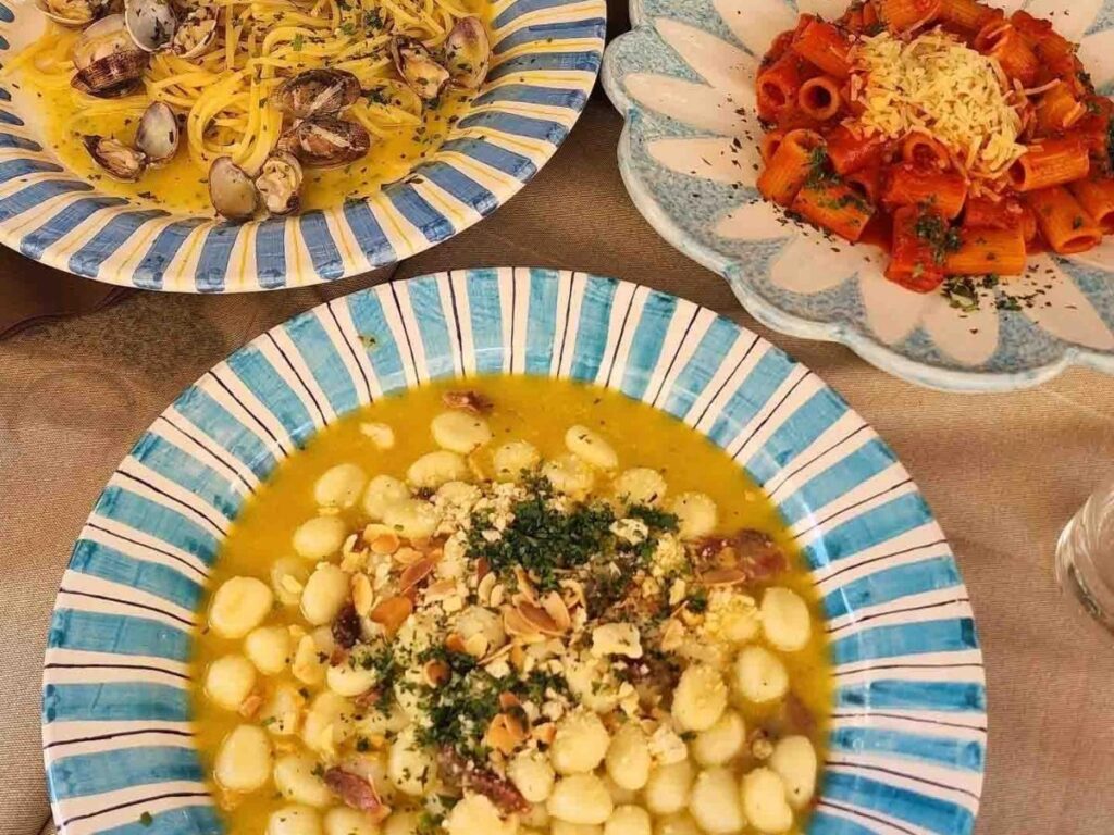 Hands shaping gnocchi during a traditional Sorrento cooking class using fresh local ingredients.