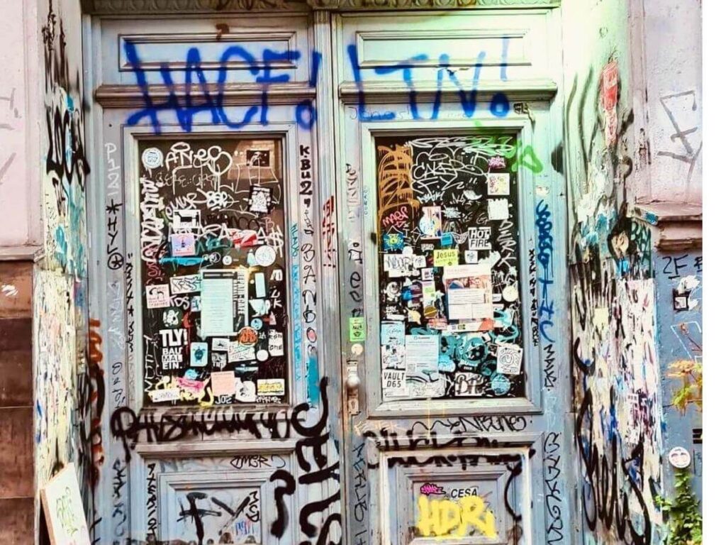 Vibrant street art and graffiti covering alley walls in Kreuzberg, Berlin