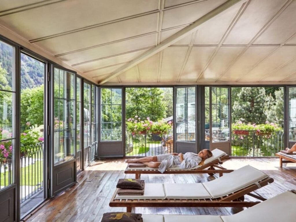 Outdoor thermal pools at Pré Saint Didier with steam rising and mountain views beyond