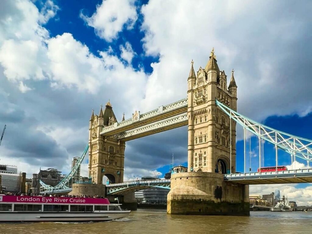 “Tower Bridge at sunset, lights reflecting in the River Thames.”
