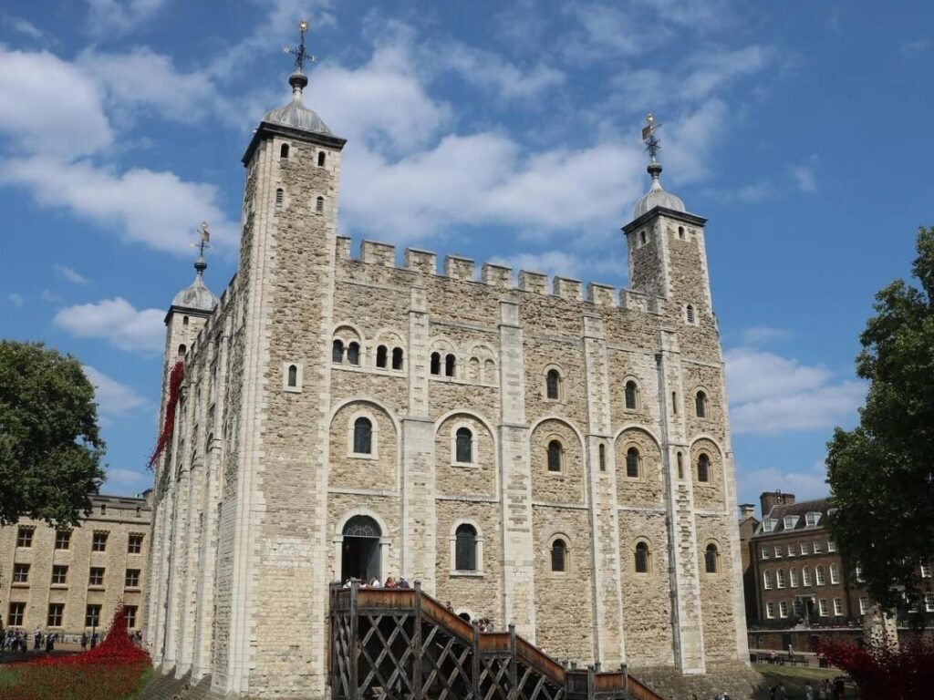The Tower of London with the River Thames and modern skyline in the background.”