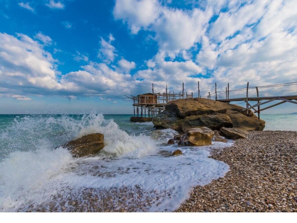 Quiet sandy beach along the Trabocchi Coast with a trabocco in the distance