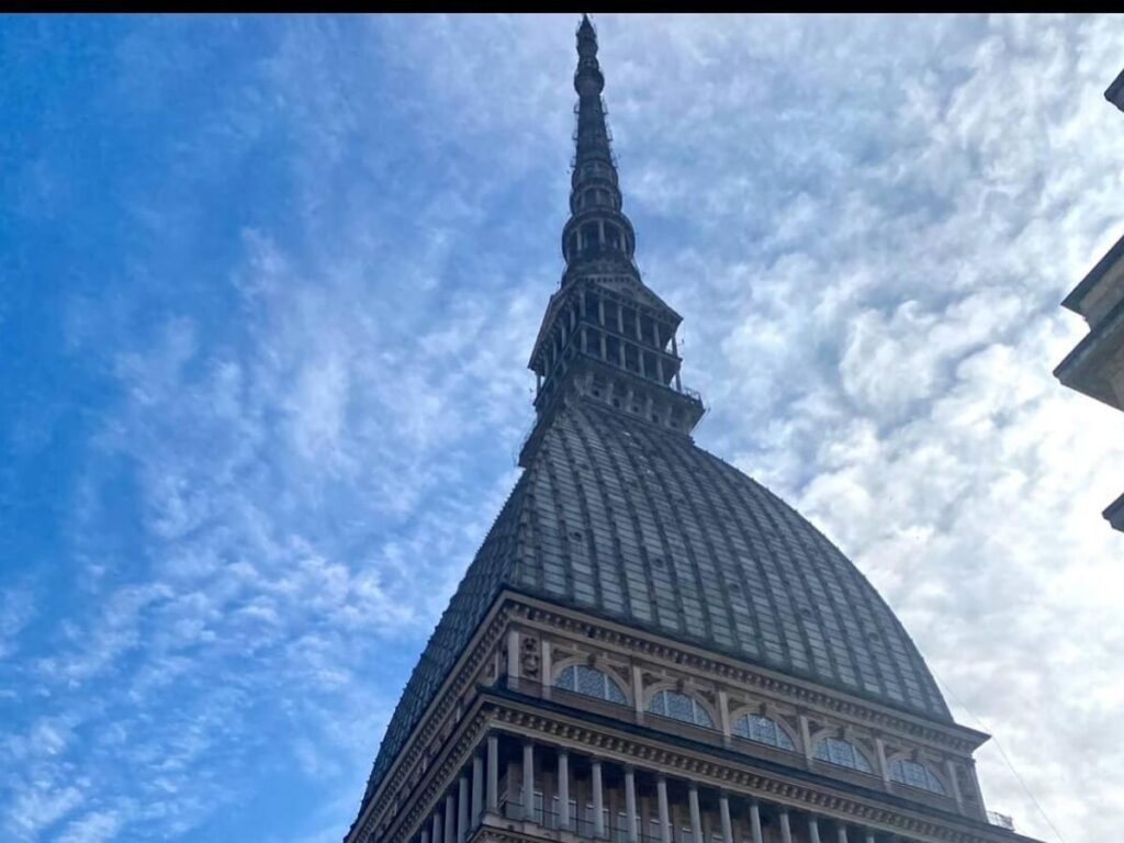 Mole Antonelliana rising above Turin’s skyline with the Alps in the distance.